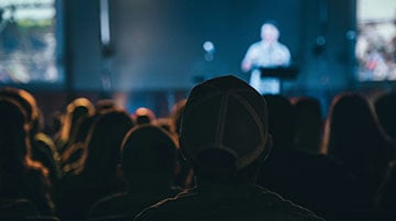 Keynote speaker addressing a conference audience