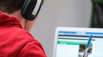 Student attending an online class on a laptop