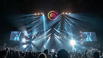 Esports arena with stage lighting and a live audience