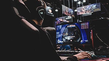 Streamer playing at a neon-lit gaming desk